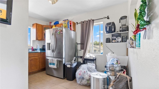 413 E 81st St, Los Angeles, CA 90003 - kitchen with stainless steel refrigerator with ice dispenser, brown cabinets, and light tile patterned floors