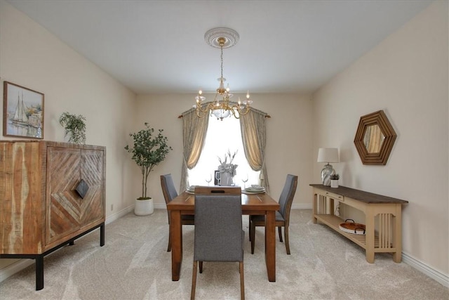 455 Chiswick Way, Cambria, CA 93428 - dining space featuring a chandelier, light carpet, and baseboards