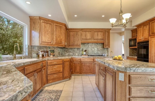 455 Chiswick Way, Cambria, CA 93428 - kitchen featuring black appliances, a sink, backsplash, brown cabinets, and a chandelier