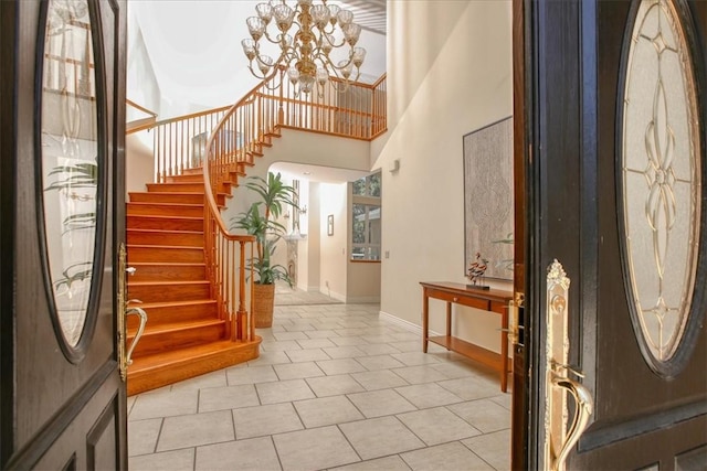 455 Chiswick Way, Cambria, CA 93428 - foyer with a chandelier, baseboards, stairs, a towering ceiling, and tile patterned flooring