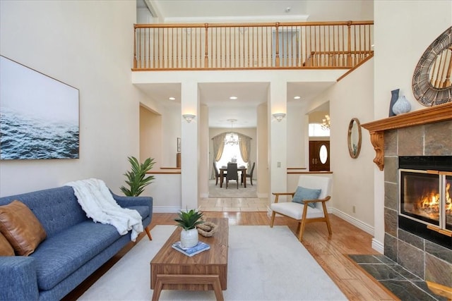 455 Chiswick Way, Cambria, CA 93428 - living room with wood finished floors, a fireplace, a high ceiling, and baseboards