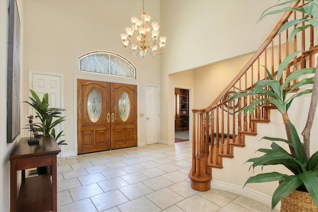 455 Chiswick Way, Cambria, CA 93428 - entryway with a towering ceiling, stairs, a chandelier, light tile patterned floors, and baseboards