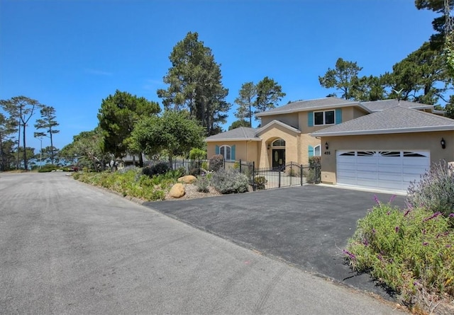 455 Chiswick Way, Cambria, CA 93428 - view of front of house with stucco siding, an attached garage, and driveway