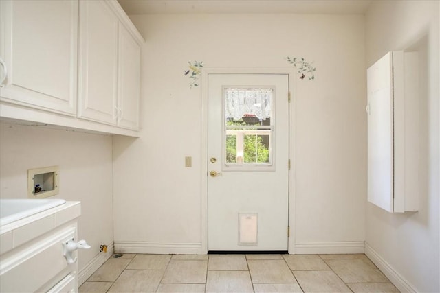 455 Chiswick Way, Cambria, CA 93428 - washroom with cabinet space, washer hookup, baseboards, and light tile patterned floors