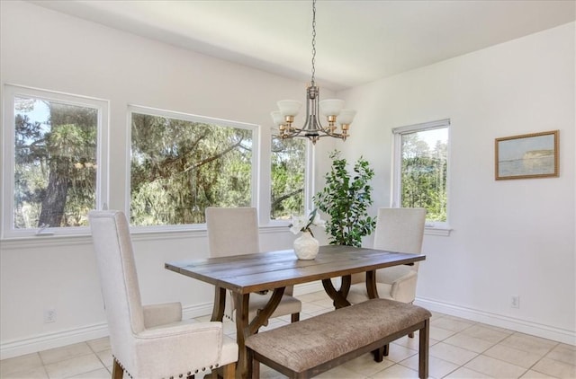 455 Chiswick Way, Cambria, CA 93428 - dining space with a chandelier, light tile patterned floors, and baseboards