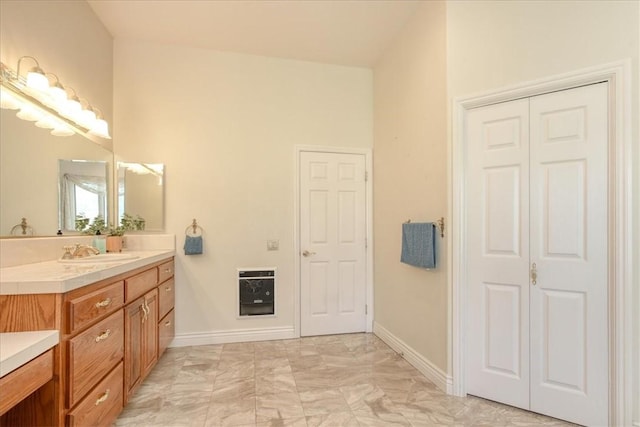 455 Chiswick Way, Cambria, CA 93428 - bathroom with heating unit, vanity, marble look tiles, and baseboards