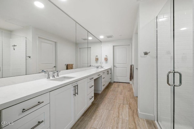 2800 Wagon Wheel Rd Unit 304, Oxnard, CA 93036 - bathroom with recessed lighting, a shower stall, wood finished floors, double vanity, and baseboards