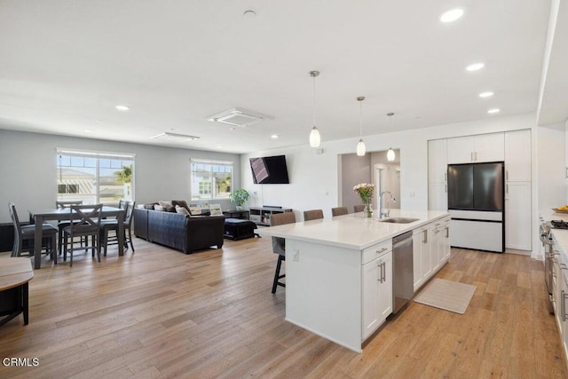 2800 Wagon Wheel Rd Unit 304, Oxnard, CA 93036 - kitchen featuring black refrigerator, a sink, dishwasher, white cabinetry, and recessed lighting