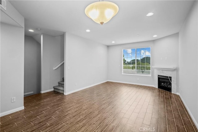 4617 Alekona Ct, Cypress, CA 90630 - unfurnished living room featuring dark wood-type flooring, stairway, a fireplace, and recessed lighting