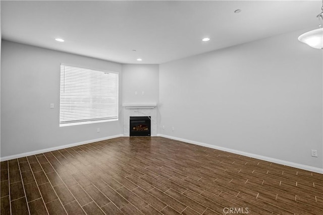 4617 Alekona Ct, Cypress, CA 90630 - unfurnished living room with dark wood-style flooring, a high end fireplace, and recessed lighting
