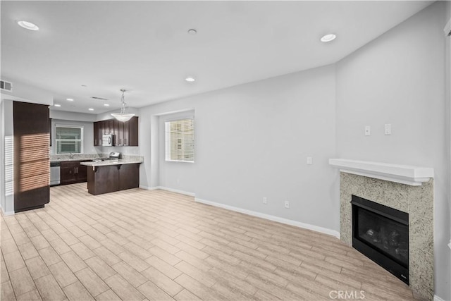 4615 Alekona Ct, Cypress, CA 90630 - kitchen with open floor plan, dark brown cabinets, light countertops, recessed lighting, and healthy amount of natural light