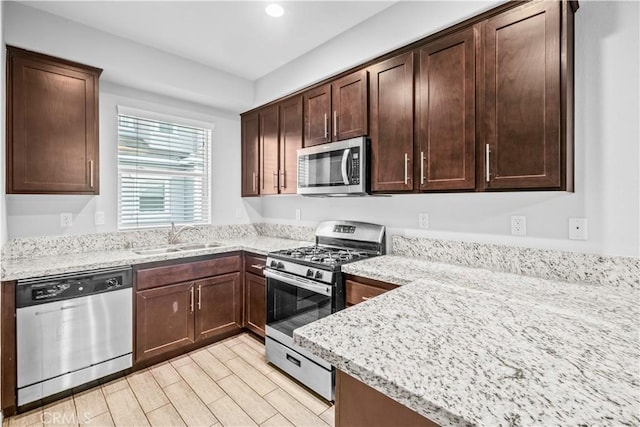 4615 Alekona Ct, Cypress, CA 90630 - kitchen with appliances with stainless steel finishes, light stone countertops, dark brown cabinets, recessed lighting, and light wood-style floors