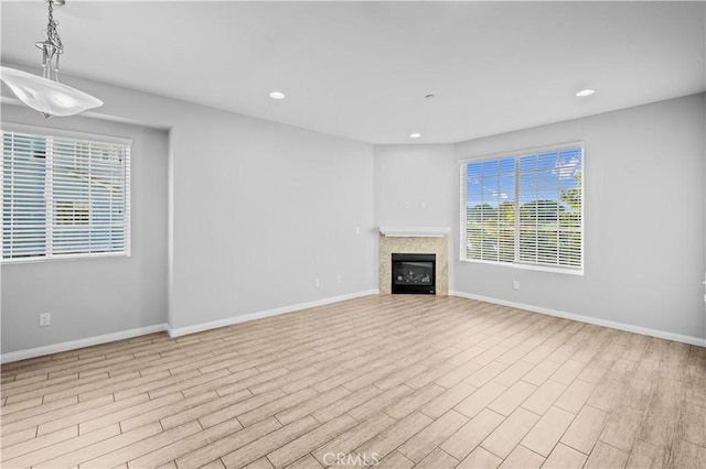 4615 Alekona Ct, Cypress, CA 90630 - unfurnished living room with wood finished floors, recessed lighting, and a glass covered fireplace