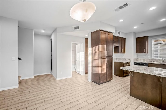 4615 Alekona Ct, Cypress, CA 90630 - kitchen with light stone countertops, dark brown cabinetry, light wood-type flooring, recessed lighting, and dishwasher