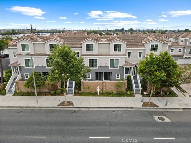 4615 Alekona Ct, Cypress, CA 90630 - view of front of property featuring stairs, a residential view, stucco siding, and stone siding