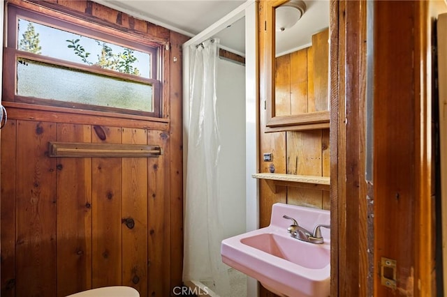 32930 Rim Of The World, Running Springs, CA 92382 - full bathroom featuring a sink, wooden walls, and curtained shower