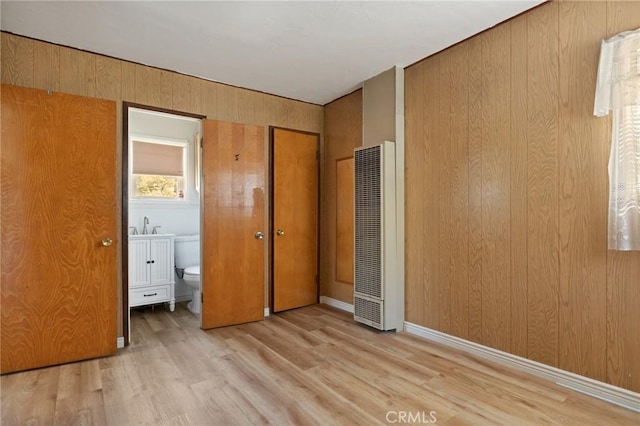 32930 Rim Of The World, Running Springs, CA 92382 - unfurnished bedroom with a heating unit, wood finished floors, ensuite bathroom, and wood walls