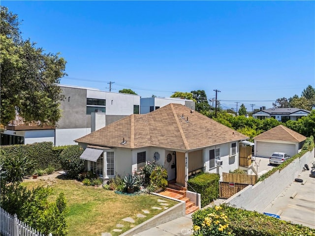 4180 Tujunga Ave, Studio City, CA 91604 - view of front of house featuring stucco siding, a detached garage, and roof with shingles