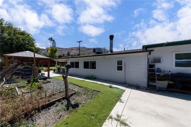 22892 Palm Ave, Grand Terrace, CA 92313 - back of property with a gazebo, a patio, and a vegetable garden