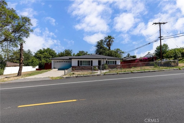 22892 Palm Ave, Grand Terrace, CA 92313 - ranch-style home featuring driveway, a garage, and a fenced front yard
