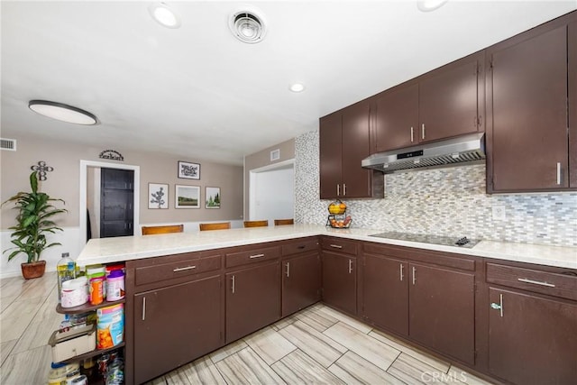 22892 Palm Ave, Grand Terrace, CA 92313 - kitchen with under cabinet range hood, a peninsula, light countertops, and black electric stovetop