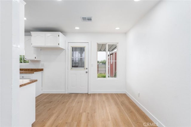 1089 W 2nd St, Rialto, CA 92376 - kitchen with white cabinetry, light wood-style flooring, baseboards, and recessed lighting