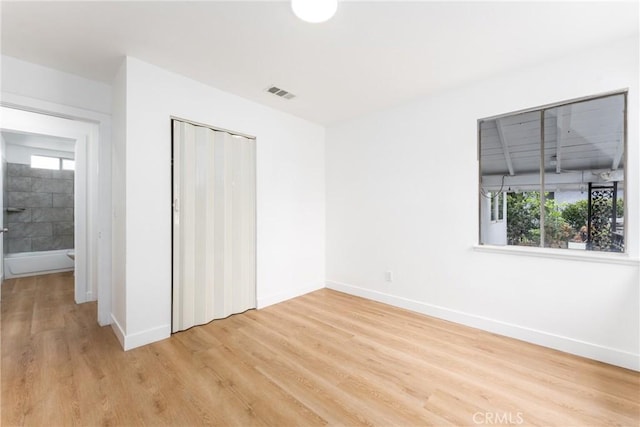 1089 W 2nd St, Rialto, CA 92376 - unfurnished bedroom with light wood-style flooring, baseboards, and a closet