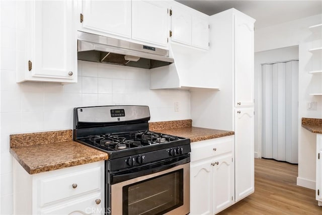 1089 W 2nd St, Rialto, CA 92376 - kitchen featuring under cabinet range hood, gas stove, white cabinets, light wood-style flooring, and backsplash
