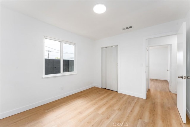 1089 W 2nd St, Rialto, CA 92376 - unfurnished bedroom with light wood-style floors, baseboards, and a closet