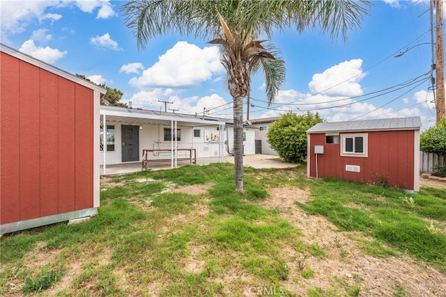 1089 W 2nd St, Rialto, CA 92376 - view of yard featuring a patio and an outbuilding