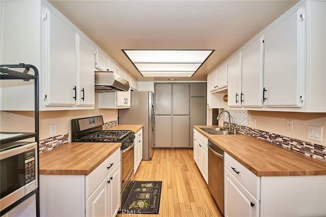 928 N Redding Way Unit D, Upland, CA 91786 - kitchen featuring butcher block countertops, stainless steel appliances, a sink, and under cabinet range hood