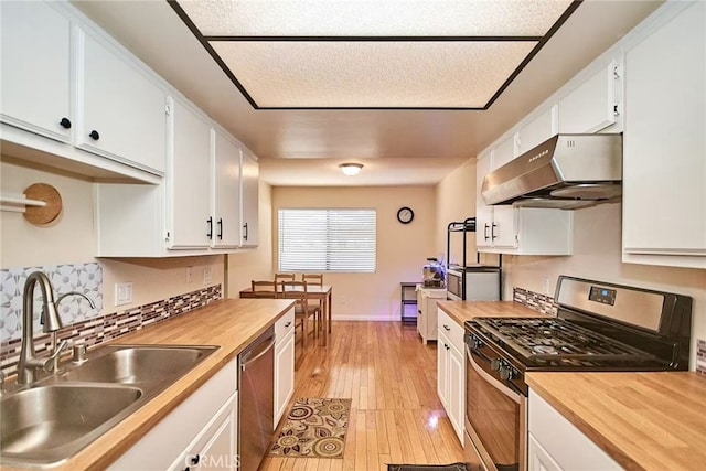 928 N Redding Way Unit D, Upland, CA 91786 - kitchen with stainless steel appliances, under cabinet range hood, a sink, and butcher block countertops