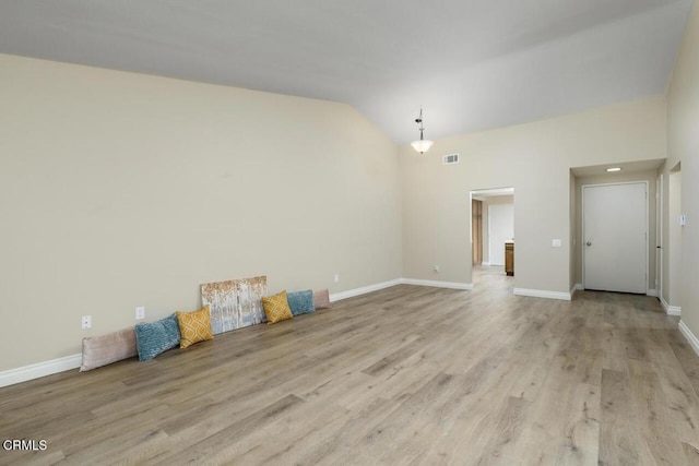 41019 Village 41, Camarillo, CA 93012 - unfurnished living room featuring light wood-type flooring, baseboards, and lofted ceiling