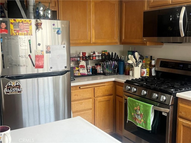 187 Woodbine Ln, Nipomo, CA 93444 - kitchen featuring stainless steel appliances, light countertops, and brown cabinets