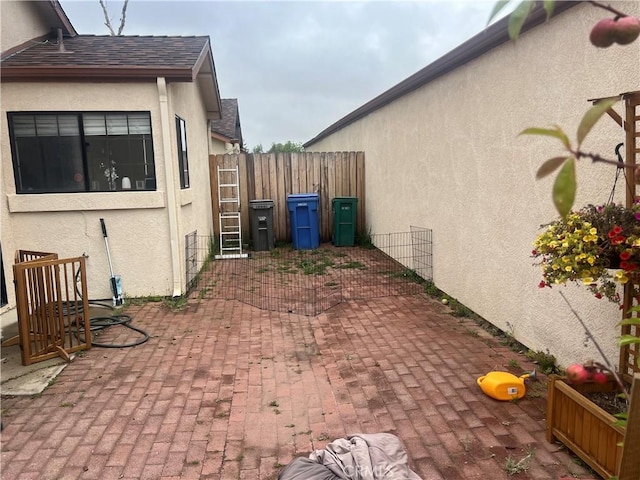 187 Woodbine Ln, Nipomo, CA 93444 - view of side of property featuring stucco siding, a patio area, and a shingled roof