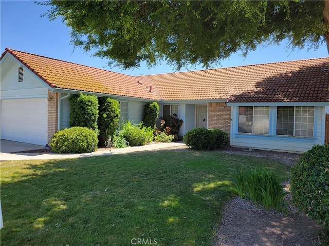 2368 Beechwood Way, Madera, CA 93637 - ranch-style house featuring a tile roof, an attached garage, and a front yard