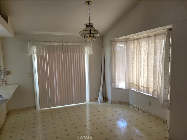 2368 Beechwood Way, Madera, CA 93637 - unfurnished dining area with tile patterned floors, lofted ceiling, a chandelier, and baseboards