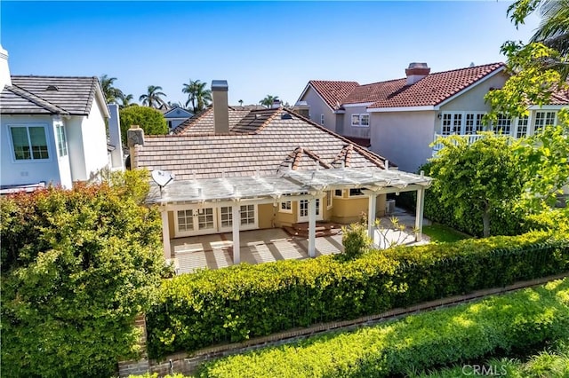 19371 Woodlands Dr, Huntington Beach, CA 92648 - rear view of house with a chimney, a pergola, stucco siding, and a patio