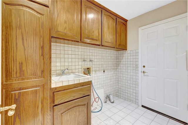 19371 Woodlands Dr, Huntington Beach, CA 92648 - laundry area with hookup for a washing machine, cabinet space, and light tile patterned floors