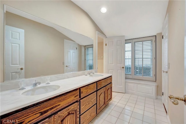 19371 Woodlands Dr, Huntington Beach, CA 92648 - full bathroom with vaulted ceiling, double vanity, and tile patterned floors