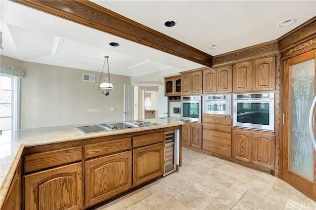 19371 Woodlands Dr, Huntington Beach, CA 92648 - kitchen featuring stainless steel oven, wine cooler, black electric cooktop, brown cabinetry, and light countertops