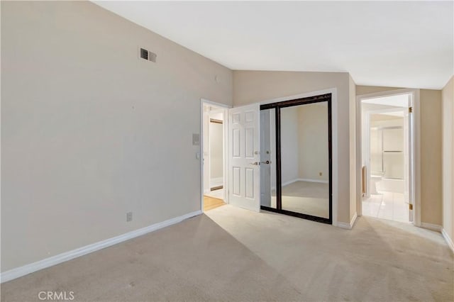 19371 Woodlands Dr, Huntington Beach, CA 92648 - unfurnished bedroom featuring lofted ceiling, light colored carpet, baseboards, and a closet