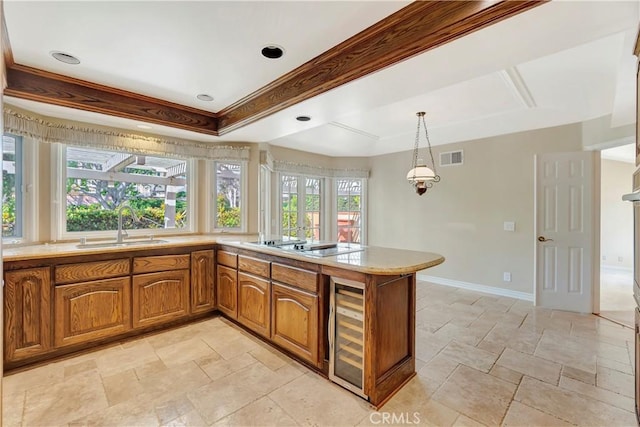 19371 Woodlands Dr, Huntington Beach, CA 92648 - kitchen with beverage cooler, a sink, brown cabinetry, a peninsula, and stone tile flooring