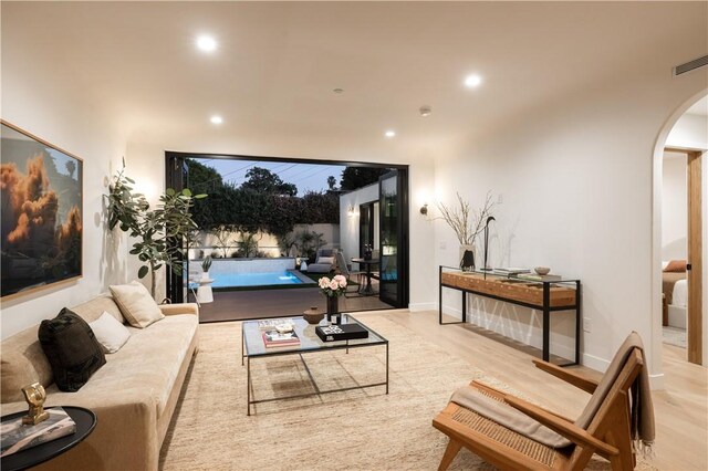 2334 Glover Pl, Los Angeles, CA 90031 - living room with arched walkways, recessed lighting, and wood finished floors