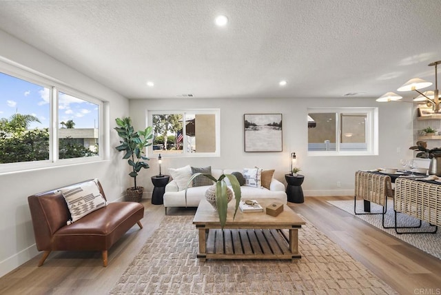 330 8th St, Seal Beach, CA 90740 - living room with wood finished floors, baseboards, plenty of natural light, a textured ceiling, and recessed lighting