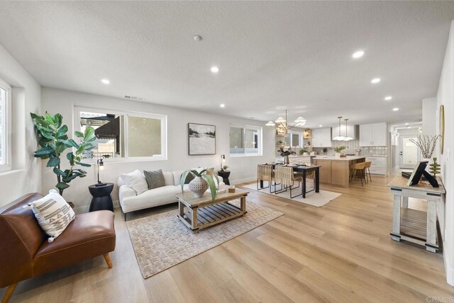 330 8th St, Seal Beach, CA 90740 - living area with recessed lighting, plenty of natural light, light wood finished floors, a textured ceiling, and baseboards