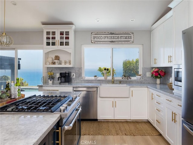 3504 Hightide Dr, Rancho Palos Verdes, CA 90275 - kitchen with appliances with stainless steel finishes, a sink, white cabinets, tasteful backsplash, and recessed lighting