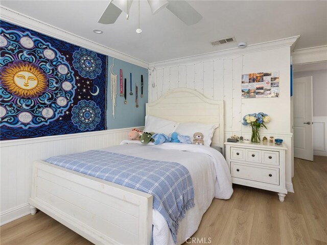 3504 Hightide Dr, Rancho Palos Verdes, CA 90275 - bedroom featuring wood finished floors, ornamental molding, wainscoting, a ceiling fan, and a decorative wall