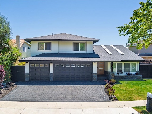 3504 Hightide Dr, Rancho Palos Verdes, CA 90275 - view of front of home with stone siding, a garage, stucco siding, a front yard, and decorative driveway