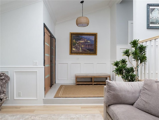 3504 Hightide Dr, Rancho Palos Verdes, CA 90275 - living area featuring a decorative wall, light wood-style floors, crown molding, lofted ceiling, and wainscoting